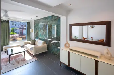 a living room with a couch and a mirror at Torch Apartments in Budva