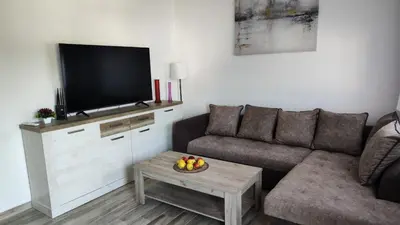 a living room with a couch and a flat screen tv at Amelia in Radanovići