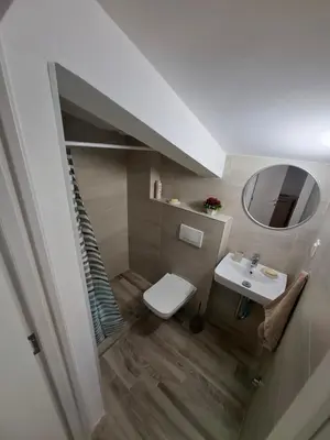 a bathroom with a sink and a toilet and a mirror at Amelia in Radanovići