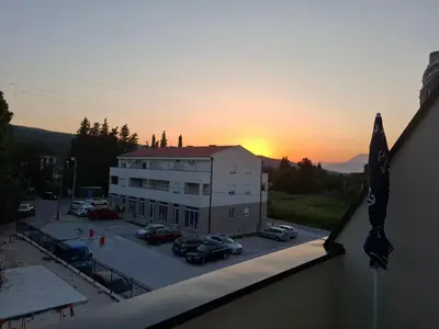 a view of a building with cars parked in a parking lot at Amelia in Radanovići
