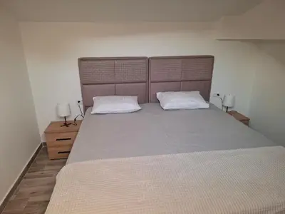 a bedroom with a large bed with two white pillows at Amelia in Radanovići