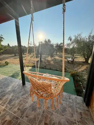 a swing on a porch with a view of a field at Salty Olives in Ulcinj