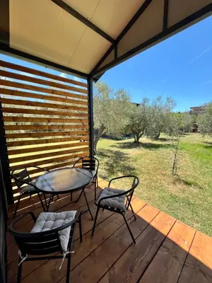 a patio with a table and chairs on a deck at Salty Olives in Ulcinj