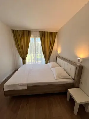 a bedroom with a large bed with a window at Salty Olives in Ulcinj