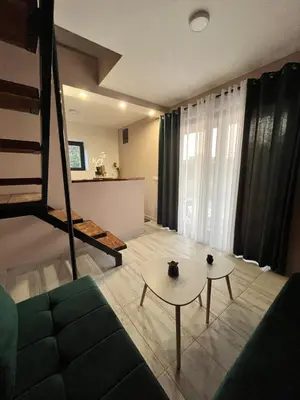 a living room with a couch and a table at Salty Olives in Ulcinj