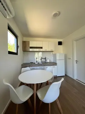 a kitchen with a table and chairs and a sink at Salty Olives in Ulcinj