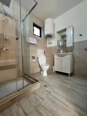 a bathroom with a shower and a toilet and a sink at Salty Olives in Ulcinj