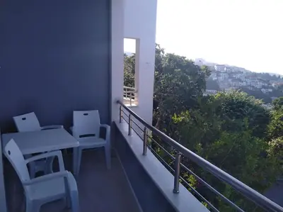 a balcony with a table and chairs and a window at Sea Violet in Ulcinj
