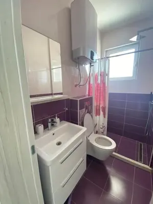 a bathroom with a white sink and a toilet at Sea Violet in Ulcinj
