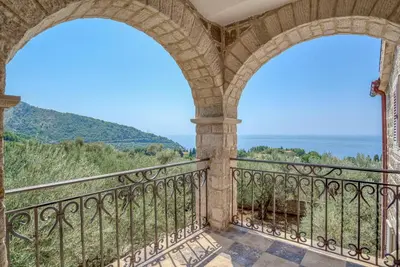 an arched balcony with a view of the mountains at Villa Olive Grove in Budva