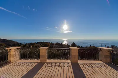 a view of the ocean from a balcony of a house at Villa Olive Grove in Budva