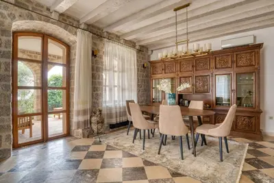 a dining room with a table and chairs at Villa Olive Grove in Budva