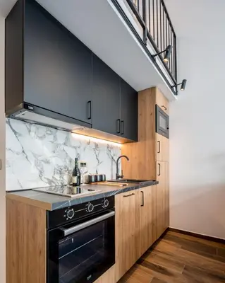 a kitchen with a sink and a stove at Appartement en Chêne in Kotor