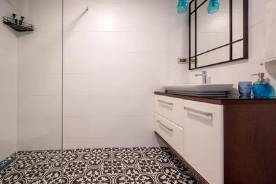 a bathroom with a sink and a tile floor at Appartement en Chêne in Kotor