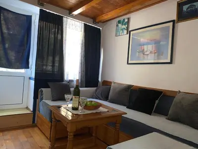 a living room with a couch and a table at Apartman Tina Gurdić in Kotor