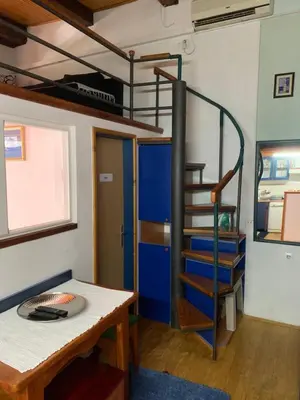 a room with a bunk bed and a spiral staircase at Apartman Tina Gurdić in Kotor