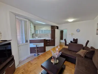 a living room with a couch and a table at Modern comfort free parking in Budva