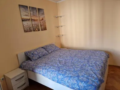 a small bedroom with a bed with a blue comforter at Modern comfort free parking in Budva