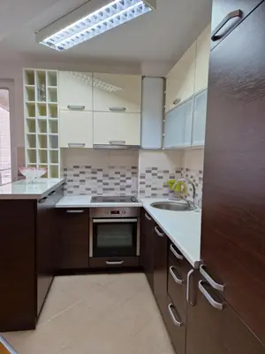 a kitchen with a sink and a stove top oven at Modern comfort free parking in Budva