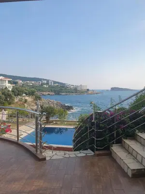 a swimming pool with a view of the water at Aurora Spa in Kunje