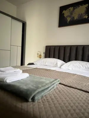 a bedroom with two beds with towels on them at DIS LUX Apartments in Radanovići