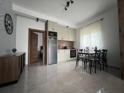 a kitchen and dining room with a table and chairs at DIS LUX Apartments in Radanovići