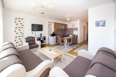 a living room with a couch and a table at Sea view Lazi in Budva
