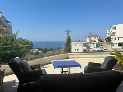 a patio with two chairs and a table on a roof at Exclusive Apartments in Ulcinj