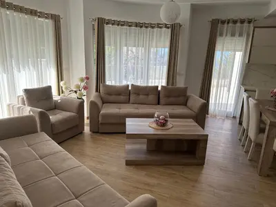 a living room with a couch and a coffee table at Exclusive Apartments in Ulcinj