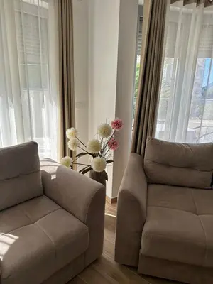 a living room with a couch and a chair at Exclusive Apartments in Ulcinj