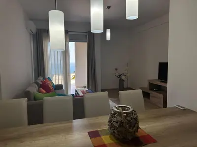 a living room with a table and a couch at Exclusive Apartments in Ulcinj