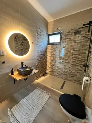 a bathroom with a sink and a glass shower at Villa Infinity Bar Montenegro in Brca