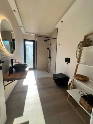 a bathroom with a sink and a toilet in a room at Villa Infinity Bar Montenegro in Brca