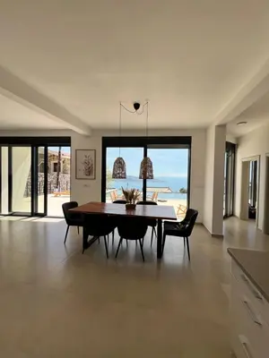 a dining room with a table and chairs at Villa Infinity Bar Montenegro in Brca