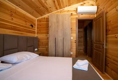 a bedroom with a bed in a wooden room at Villa Boga on Ada Bojana in Gornji Štoj