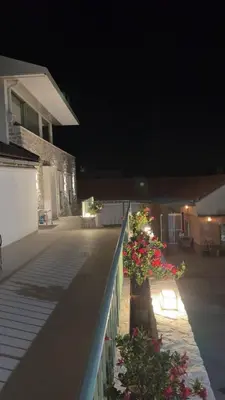 a balcony with flowers on a house at night at Happy Holiday House Hava in Ravanj