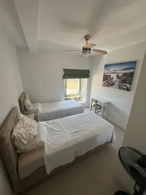 a bedroom with two beds and a ceiling fan at Happy Holiday House Hava in Ravanj