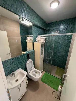 a bathroom with a toilet and a sink and a shower at Happy Holiday House Hava in Ravanj