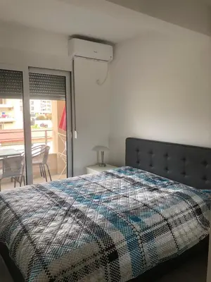 a bedroom with a bed with a quilt on it at Apartment Radoncic in Ulcinj