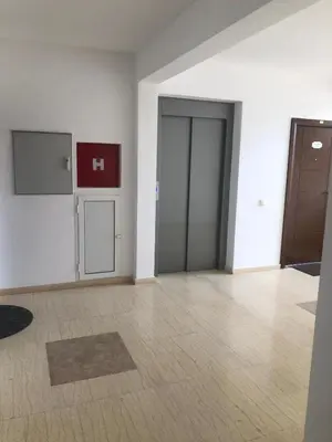 an empty room with two doors and a tile floor at Apartment Radoncic in Ulcinj