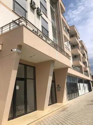 a building with a balcony on the side of it at Apartment Radoncic in Ulcinj