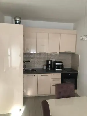 a kitchen with white cabinets and a counter top at Apartment Radoncic in Ulcinj