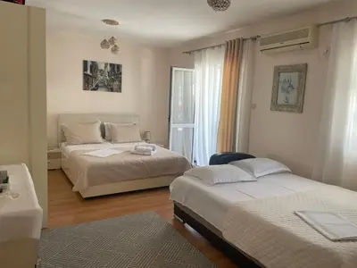 a bedroom with two beds and a window at Premium apartments in Ulcinj