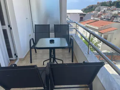 a table and chairs on a balcony with a view at Premium apartments in Ulcinj