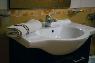 a white bathroom sink with a towel on it at Premium apartments in Ulcinj