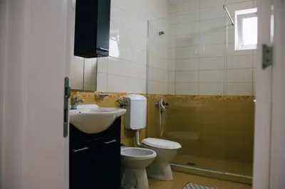 a bathroom with a sink and a toilet and a shower at Premium apartments in Ulcinj