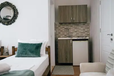 a small room with a bed and a kitchen at Premium apartments in Ulcinj