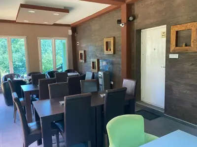 a dining room with tables and chairs in a restaurant at Izletiste Pocivala in Podgorica