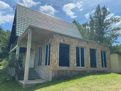 a small house with windows and a roof at Izletiste Pocivala in Podgorica