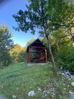 a gazebo on a hill with a tree at Izletiste Pocivala in Podgorica